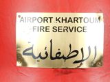 a sign on a red fire hydrant that says airport khartoum fire service