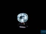 a close up of a blue diamond on a black surface