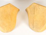 pair of wooden bookends on a white surface with a white background