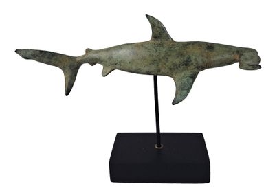 an image of a statue of a shark on a black stand