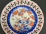 a blue and white plate with orange flowers on it