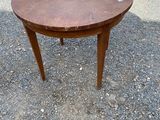 an image of a small round table on a gravel ground