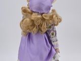 doll with blonde hair wearing a purple dress and bonnet