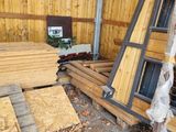several pieces of wood are stacked on top of each other in a shed