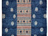 a blue rug with circles and dots on it