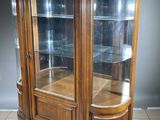 an image of a wooden display cabinet with glass doors