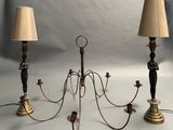 two lamps that are on a table with a clock in the background