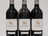 three bottles of wine sitting on top of a white table