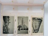 three pictures of a building on the wall of a room