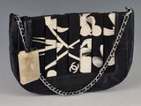 an image of a purse with scissors and a tag on it