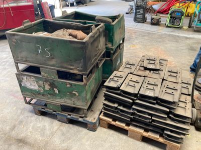a pile of old crates sitting on a pallet in a garage