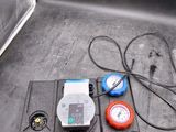 wires and gauges on the back of a boat with a clock on it