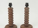 pair of wooden table lamps with geometric designs on the bases