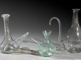 three glass vases that are sitting on a table