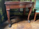 a wooden desk with a mirror on top of it