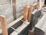 several pieces of wood are stacked on top of each other in a room