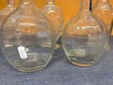 three glass vases sitting on a table with a price tag