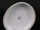 a close up of a white plate on a black surface