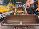 a large orange truck that is parked next to other trucks
