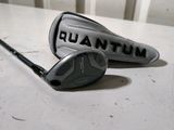 two golf clubs sitting on top of a table next to each other