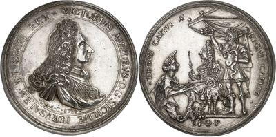 a close up of a silver coin with a picture of a man and woman on it