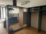 a mirror in the middle of a room with a wooden floor
