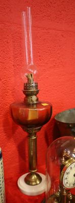 a clock and a lamp on a table with a red wall