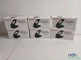 four boxes of black and white items sitting on top of a white floor