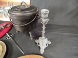 a black pot sitting on top of a table next to other items