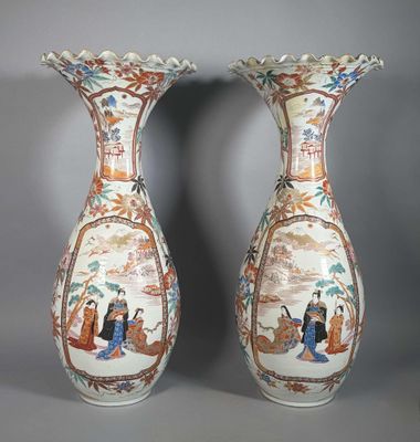 pair of chinese vases with oriental scenes on them on a gray background