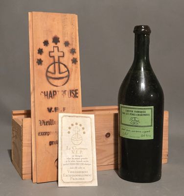 a bottle of wine sitting next to a wooden box