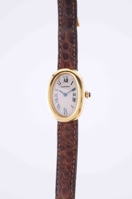 a close up of a wrist watch with a brown strap