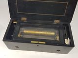 a black box that has a musical box inside of it