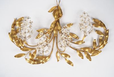 une image représentant une broche en forme de feuille d'or et de fleur sur fond blanc