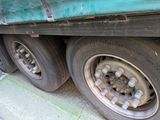 a green truck that is parked on the side of the road