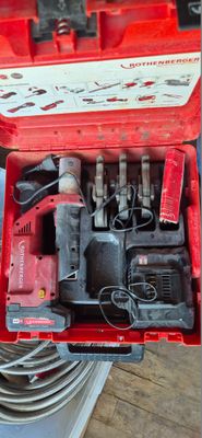 a red tool box with tools in it on a table