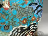 a blue vase with a design on it sitting on a table