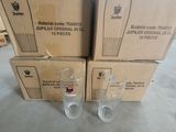 three empty glasses sitting on top of a pile of cardboard boxes
