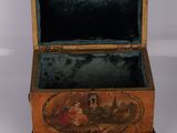an old wooden box with a painting on it sitting on a white surface