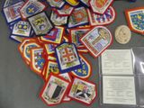 a pile of patches and a coin on a table