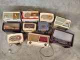 many old fashioned radio ' s sitting on the floor