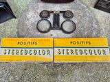 two signs that are on the ground next to a pair of scissors