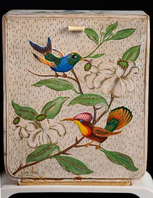 two birds sitting on a branch of a tree next to a white flower