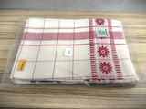 a red and white towel sitting on a wooden table