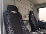 two seats in the back of a bus with a laptop on the seat