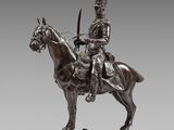 a bronze statue of a man on a horse with a sword