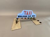 a small toy car with a taxi sign on top of it