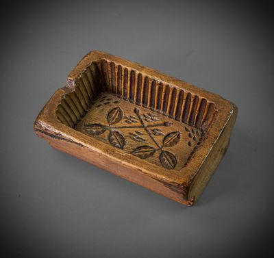 an old wooden box with a design on it