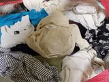 a suitcase full of clothes and a hat on the floor