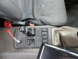 a close up of a car ' s center console with a phone in it